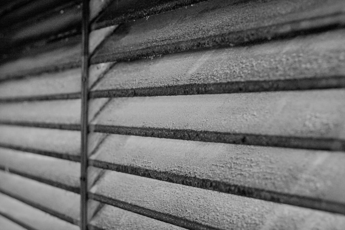 black and white photo of vent slats in an underground parking lot